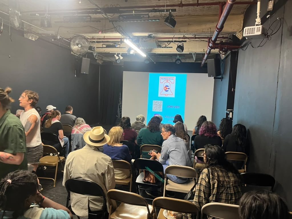 A full room of community members listens to a presentation at a P4C Philadelphia event.