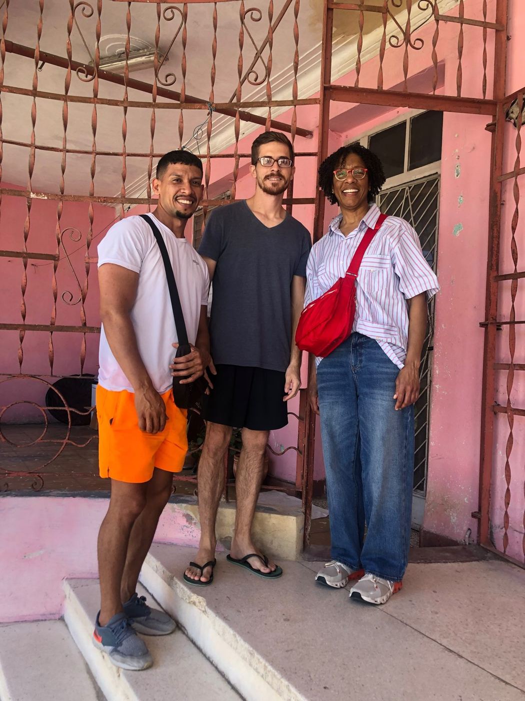 Dr. Quarterman with fellow travelers on a pink stairway in Cuba.
